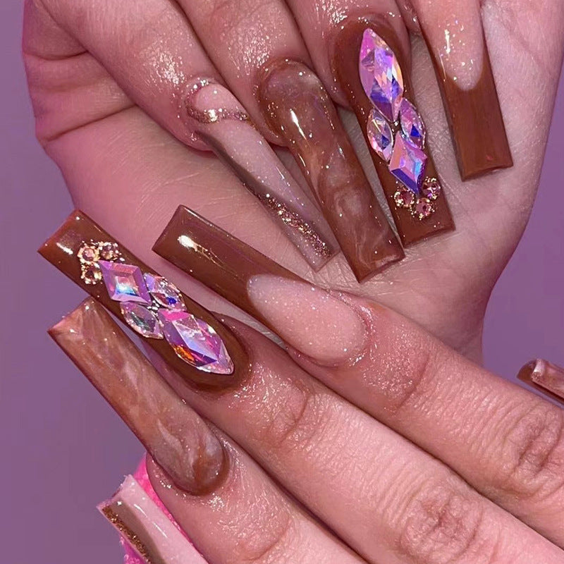 Artificial nail extensions with elegant gemstone embellishments Bowlift
