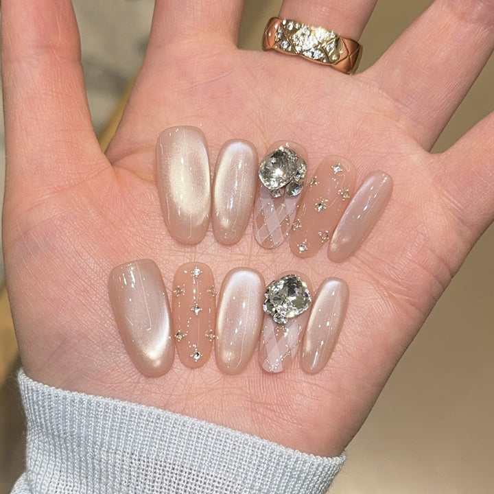 Elegant artificial nails with shimmering effects and rhinestone accents Bowlift