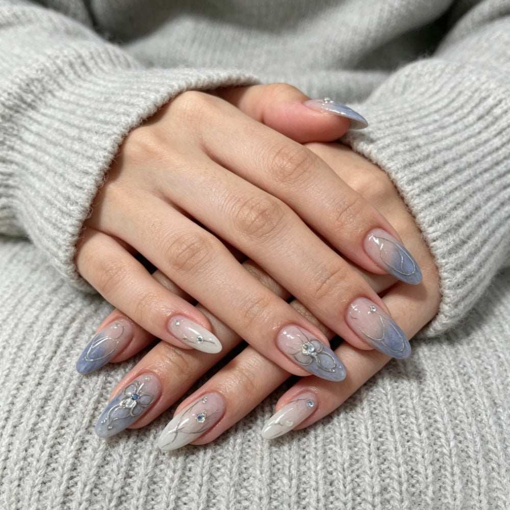 Artistic Press-On Nail Design with Floral and Gem Accents Bowlift