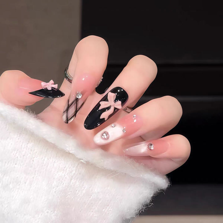 Artificial nails with playful bow and glitter accents Bowlift