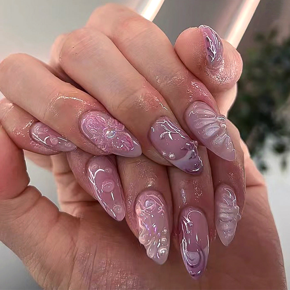 Artificial nail extensions with delicate floral designs and glitter accents Bowlift