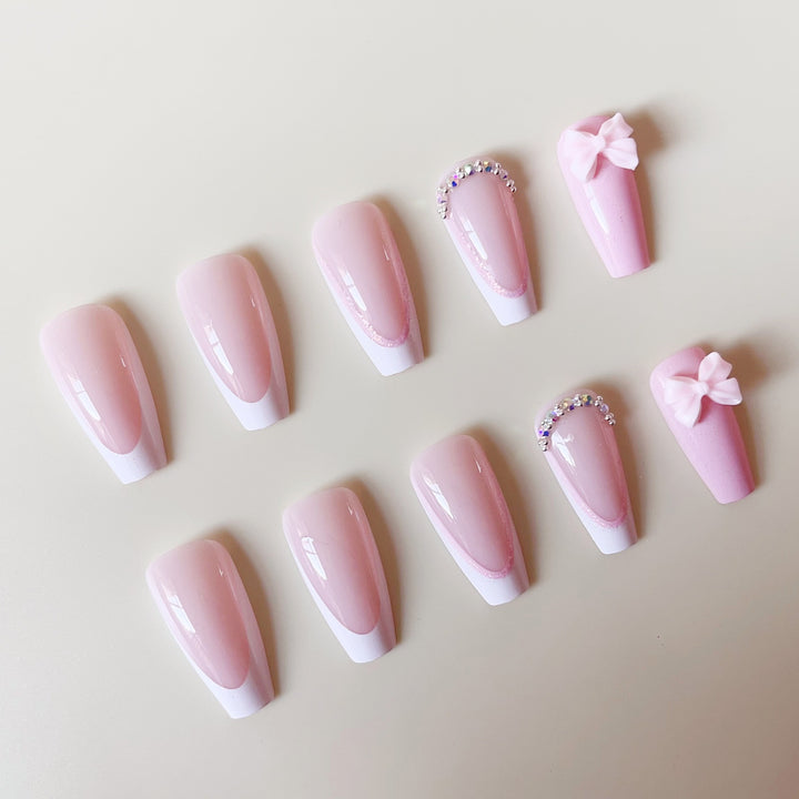 Artificial nail set with playful bows and glitter accents Bowlift