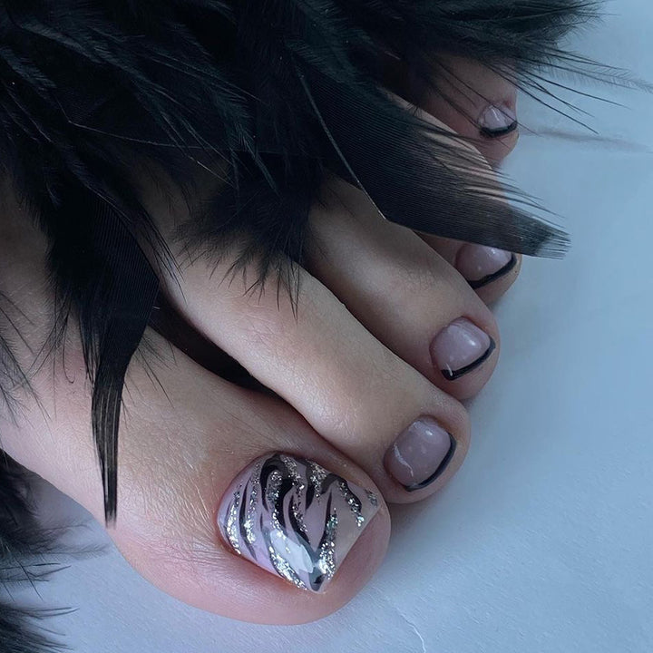 Artificial toenail art in elegant black and white design Bowlift