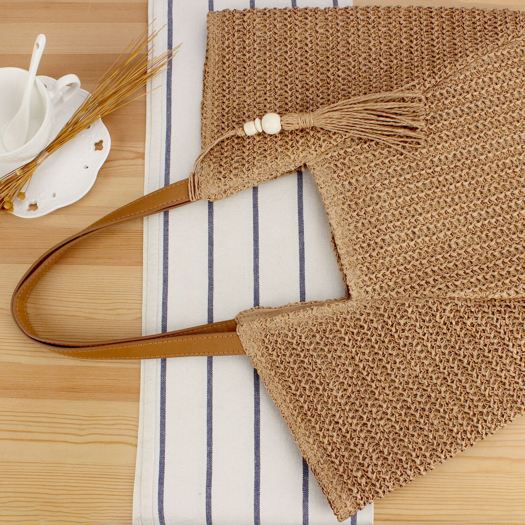 Beach bag made of natural weave with elegant leather accents Bowlift