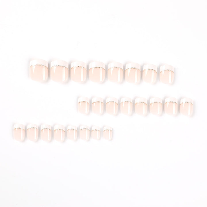 Artful nail extensions with elegant French tip and gold accents Bowlift