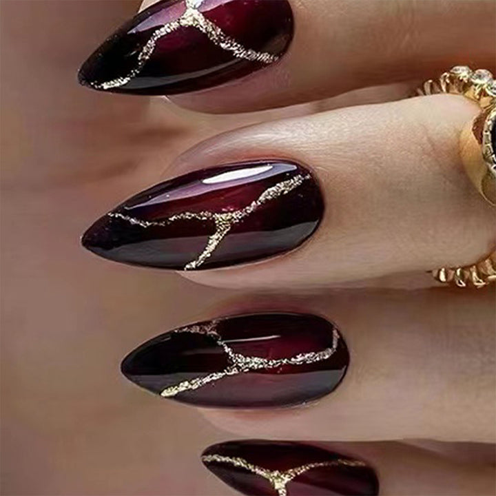 Elegant artificial nails with golden accents Bowlift