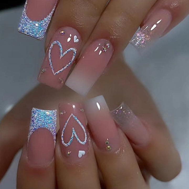 Artificial nails with sparkling heart designs and glitter details Bowlift