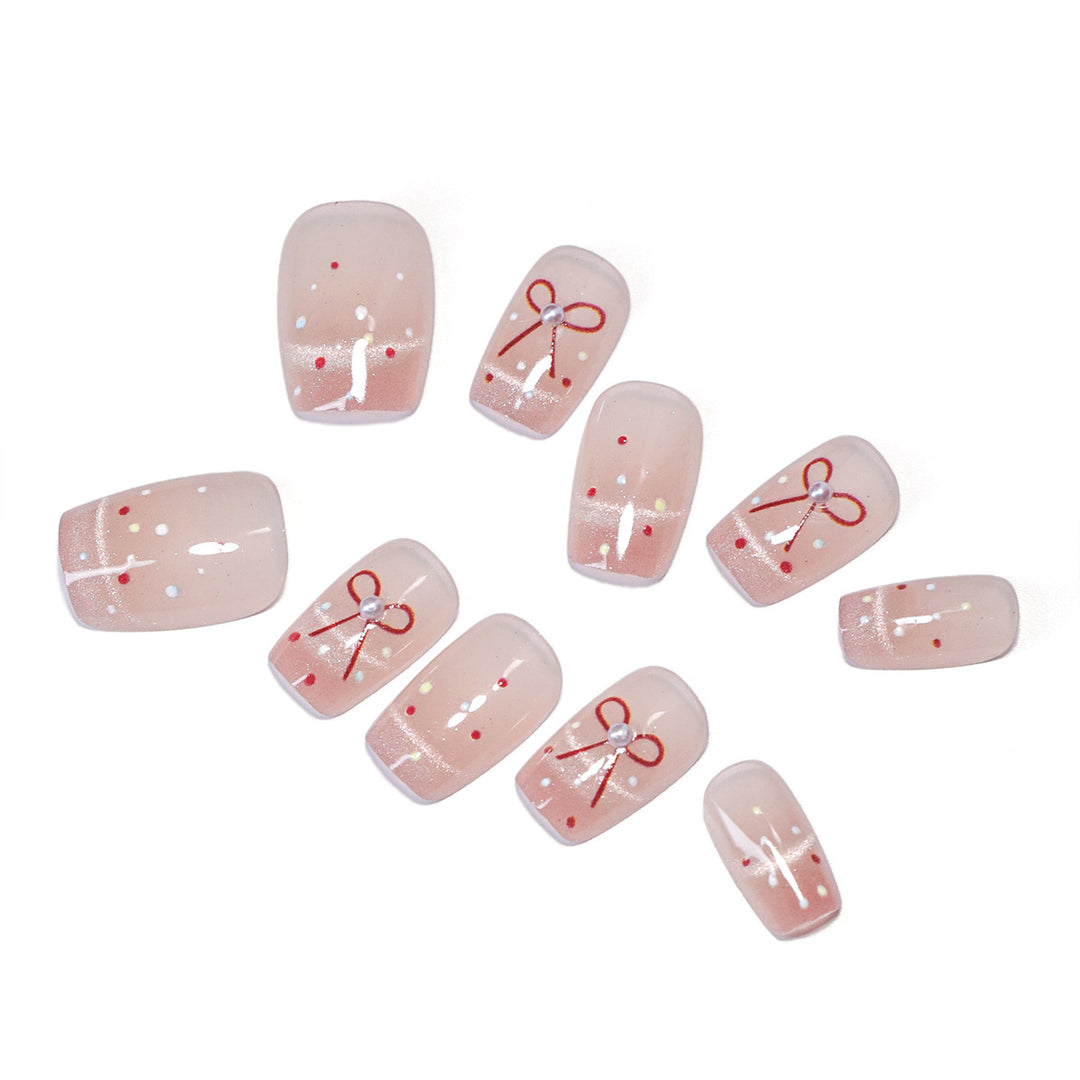 Artificial nail art with elegant bows and glitter accents Bowlift