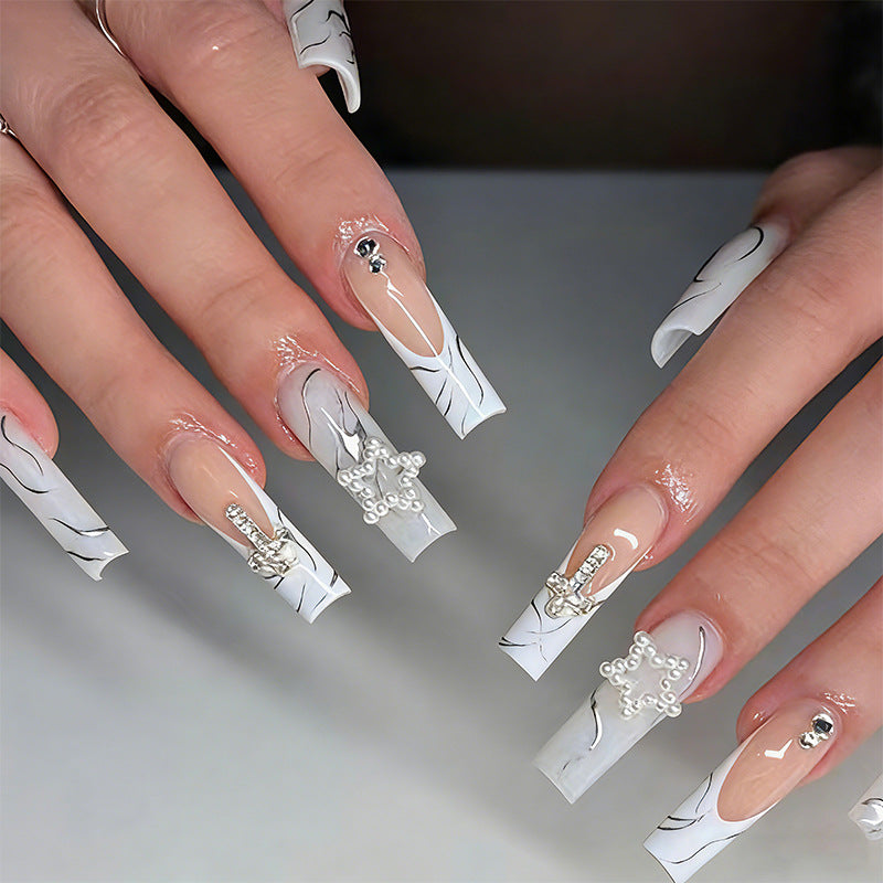 Artificial nails with luxurious marble design and radiant embellishments Bowlift