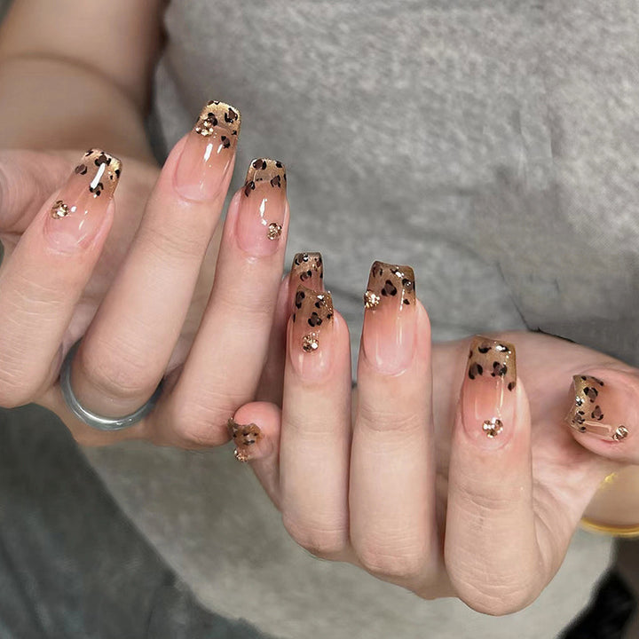 Artificial nails with shimmering leopard design and elegant accents Bowlift