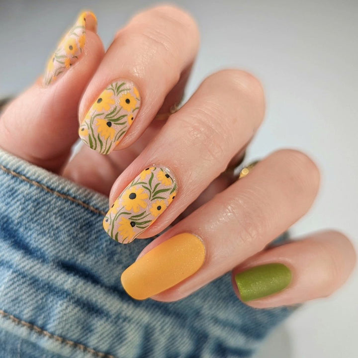 Artistic nail extensions with floral designs and creative color accents Bowlift