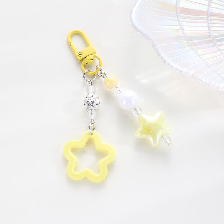 Playful keychain with floral and star motif Bowlift