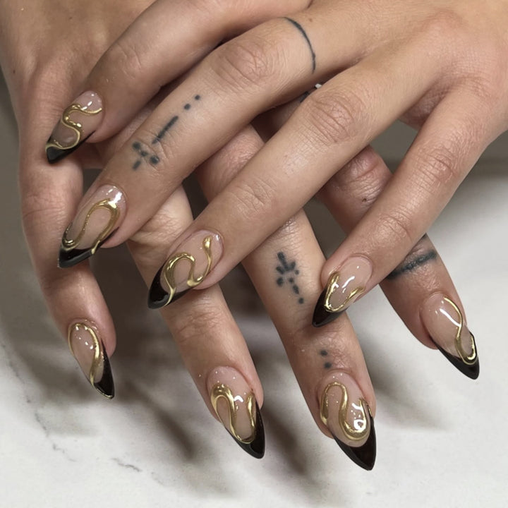 Artful stiletto nails with elegant gold design Bowlift