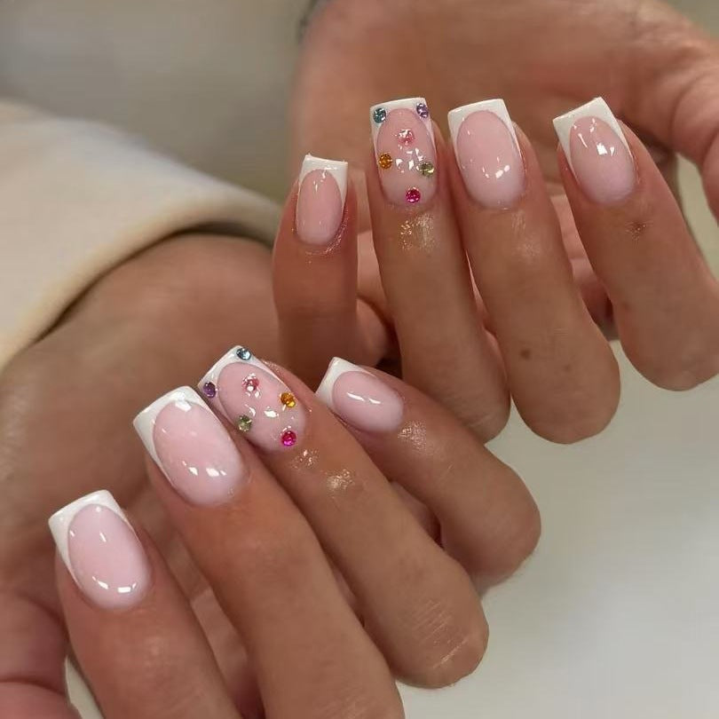 Nail art set with elegant French tips and sparkling rhinestone embellishments Bowlift