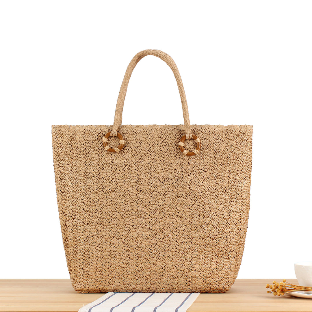 Beach bag made of natural woven material with sturdy carry handles Bowlift