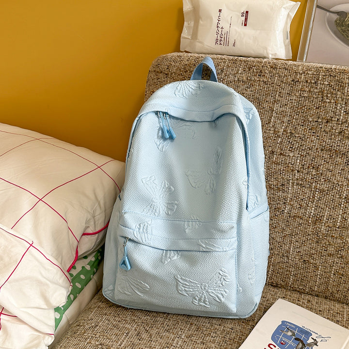Elegant Textured Backpack with Decorative Charm