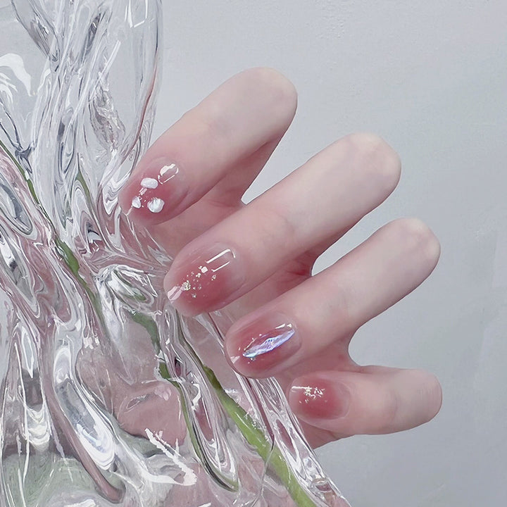 Artificial nails with delicate glitter design and floral accent Bowlift
