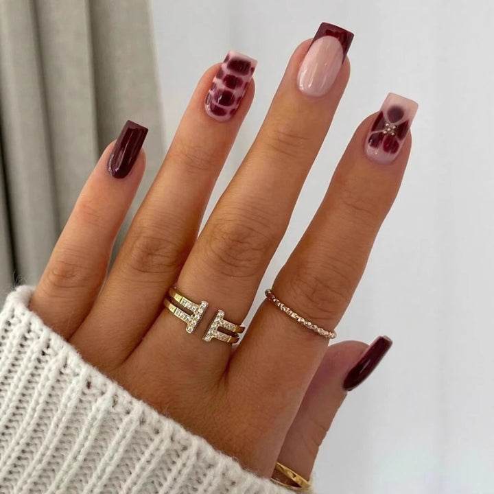 Artificial nail set with elegant geometric designs and accentuating rhinestone details Bowlift