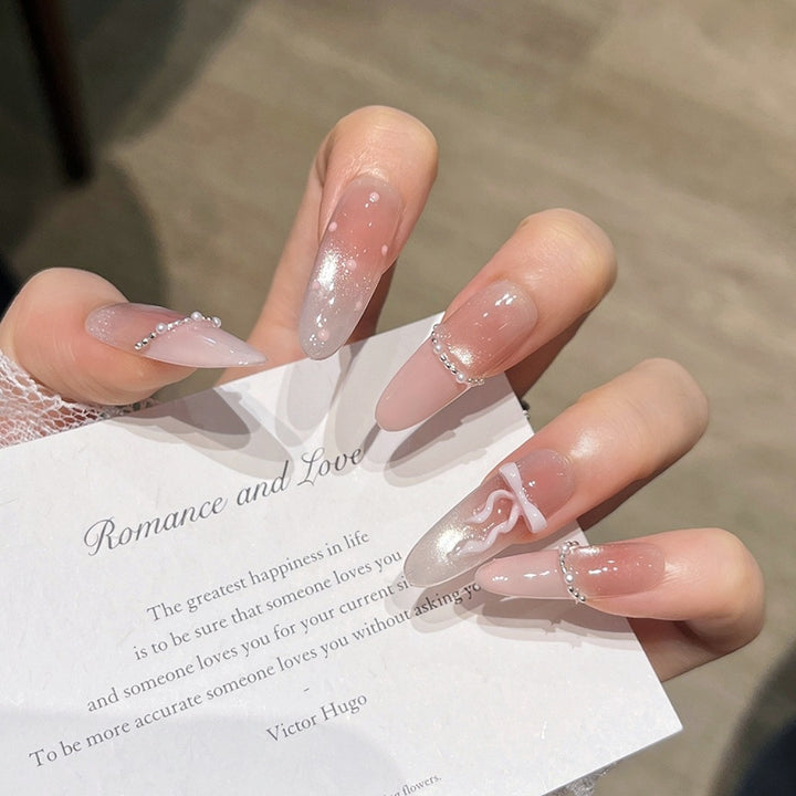 Elegant Long Press-On Nails with Decorative Accents Bowlift