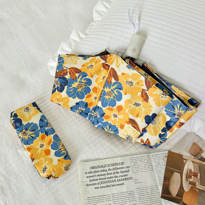 Women Folding Umbrella with Detailed Floral Design Bowlift