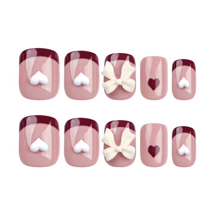 Artful nail art with heart and bow motifs Bowlift
