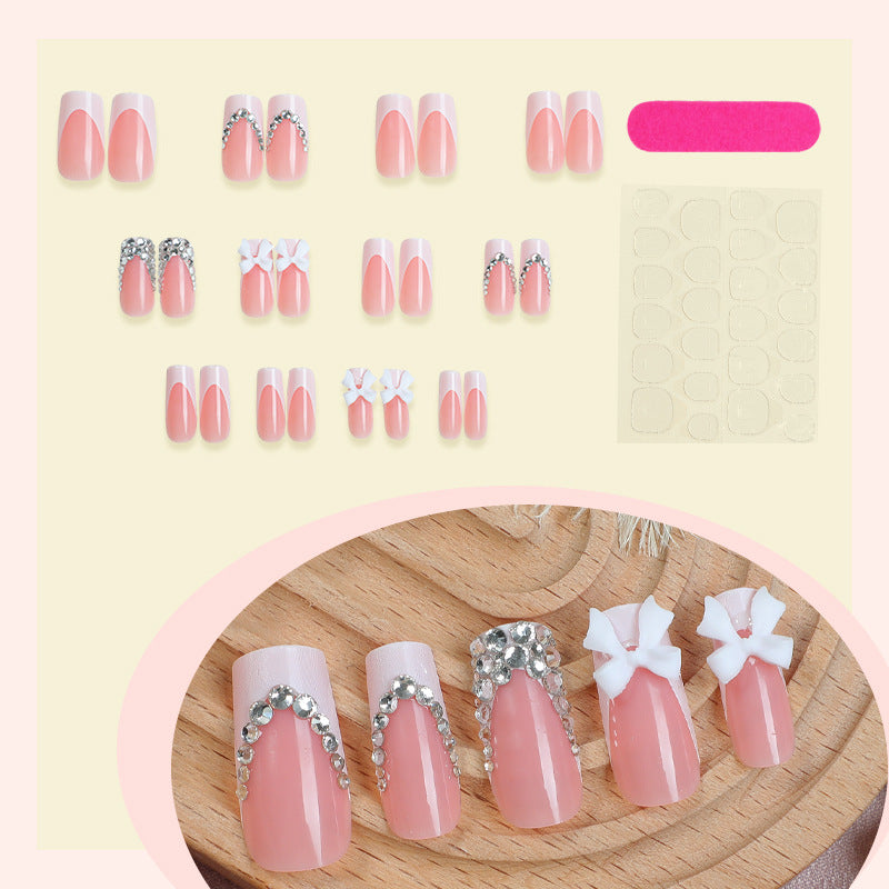 Acrylic nail set with glitter accents and decorative bows Bowlift