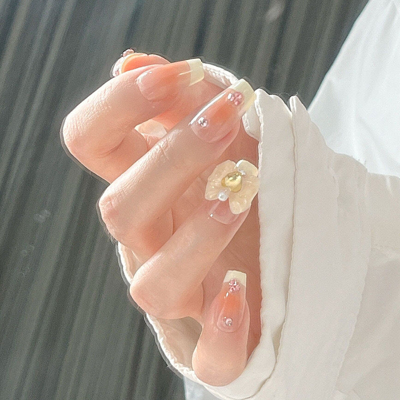 Artificial nail set with elegant floral decorations and glitter accents Bowlift