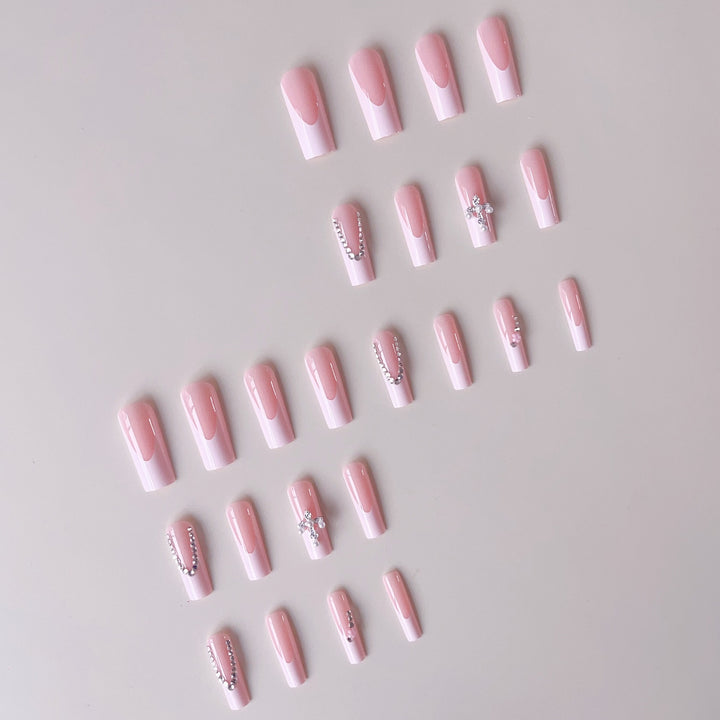Acrylic nail set with glamorous rhinestone decorations and elegant French tips Bowlift
