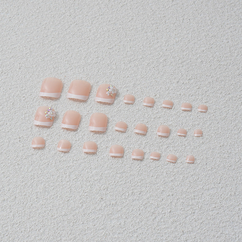 Artificial nail set with elegant French tip design and sparkling accents Bowlift