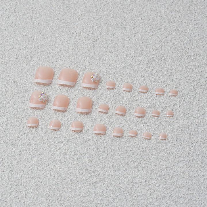 Artificial nail set with elegant French tip design and sparkling accents Bowlift