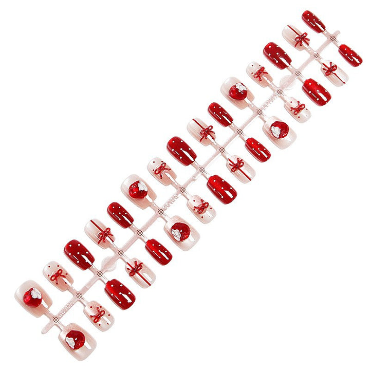 Artificial nail set with festive gift design and elegant glitter accents Bowlift