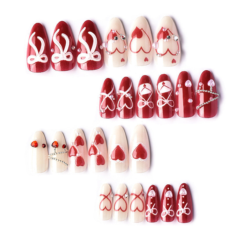 Glamorous artificial nail set with romantic heart design and elegant embellishments Bowlift