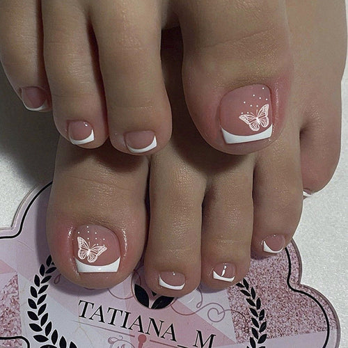 Artful toenail design with elegant butterfly motifs and French design Bowlift