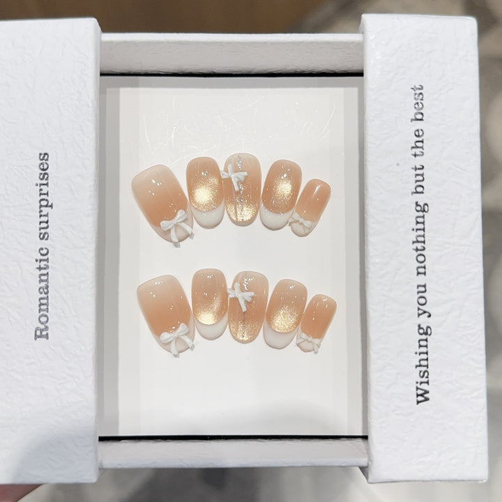 Artificial nails with romantic bow and glitter effects Bowlift