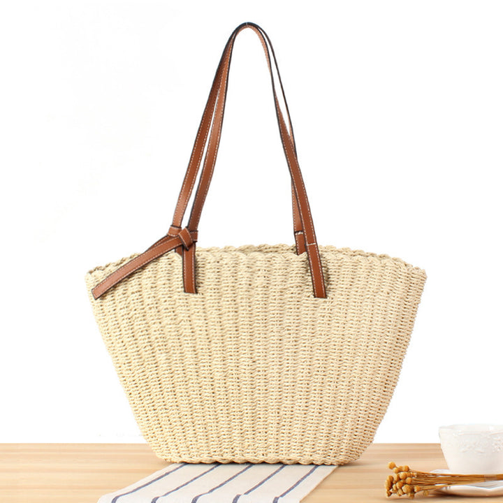 Beach bag made of handwoven natural material with sturdy leather straps Bowlift