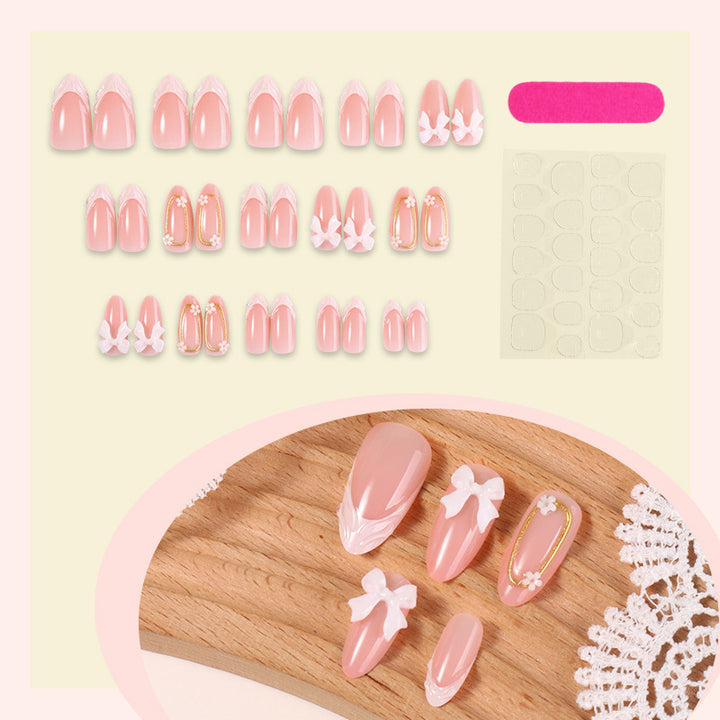 Artificial nail set with playful bow accents and delicate embellishments Bowlift