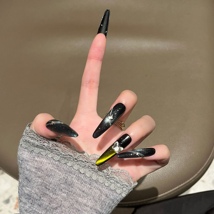 Artistic Stiletto Nail Extensions with Metallic Accents Bowlift
