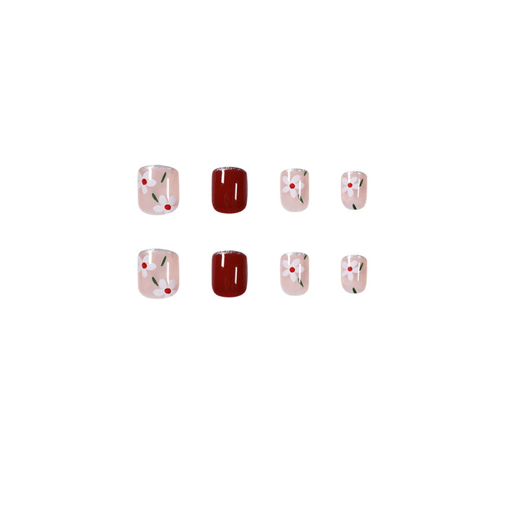 Artful nail art with floral motifs and glitter accents Bowlift