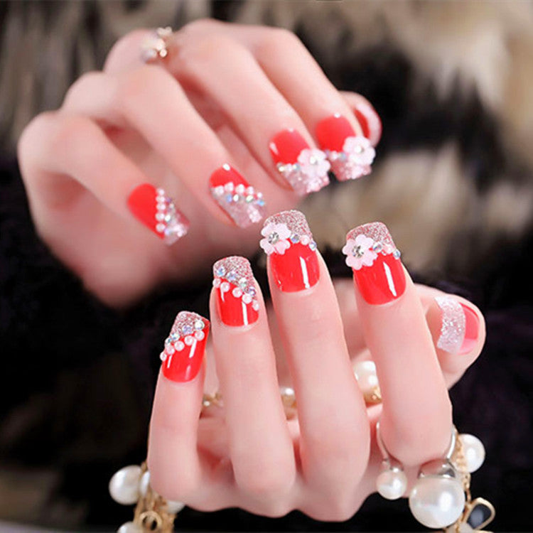Artificials nails with sparkling rhinestone accents and elegant flower embellishments Bowlift