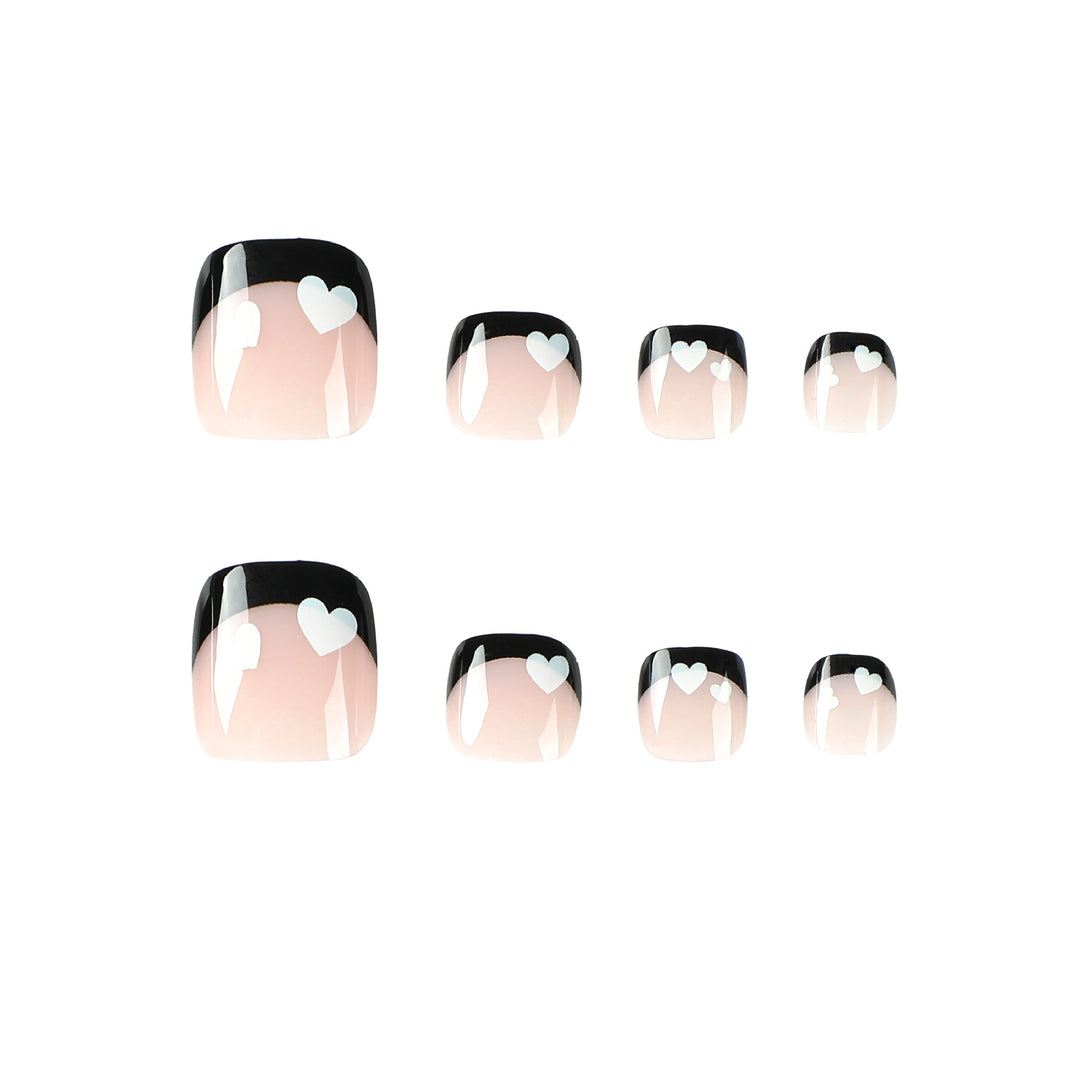 Artistic toenail design with heart motifs and modern black-and-white design Bowlift