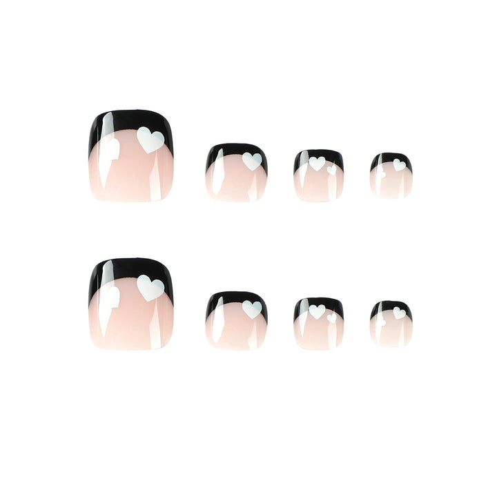 Artistic toenail design with heart motifs and modern black-and-white design Bowlift