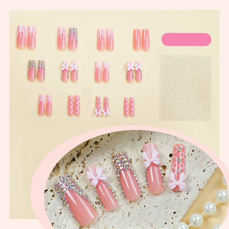 Acrylic nail set with luxurious rhinestone embellishments and bow accents Bowlift