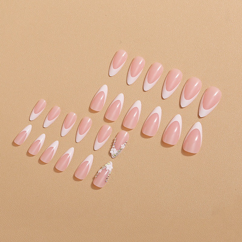 Artificial nails with elegant French tips and rhinestone details Bowlift