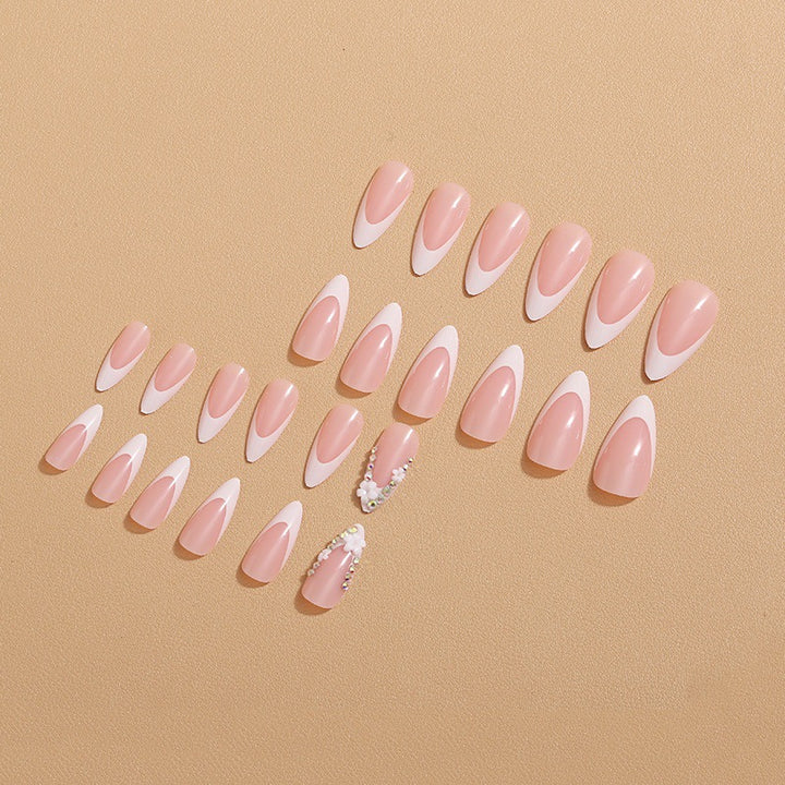 Artificial nails with elegant French tips and rhinestone details Bowlift
