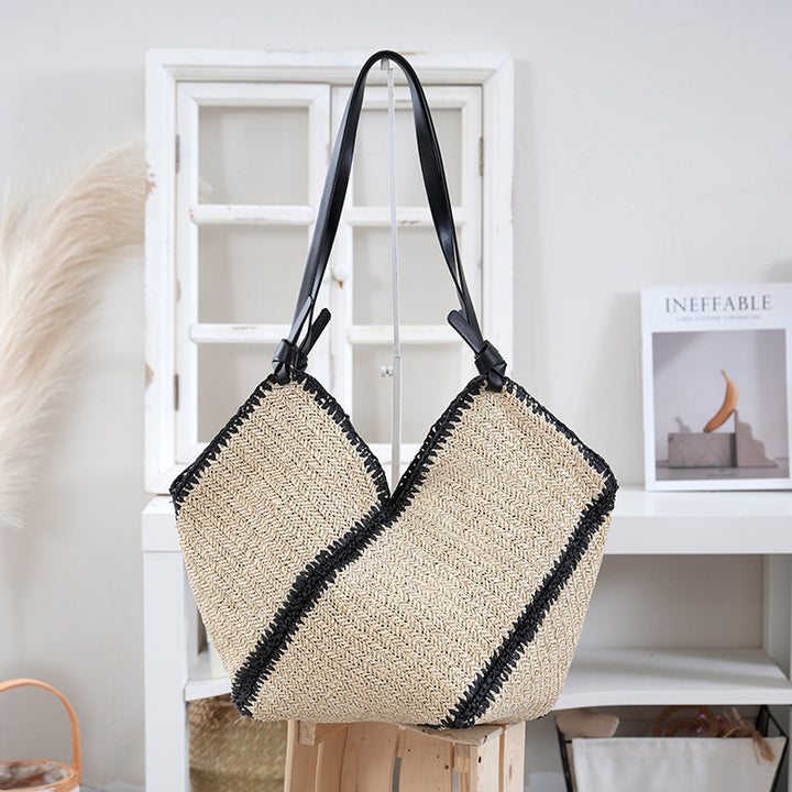 Handbag made of braided natural material with contrasting leather handles Bowlift