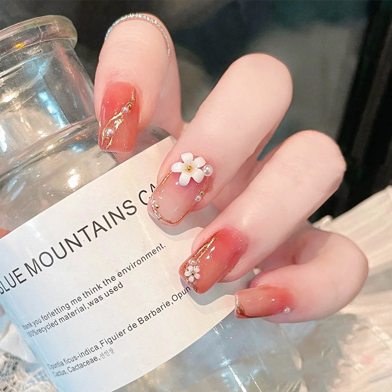 Acrylic nail set with elegant floral decorations and glamorous pearl accents Bowlift
