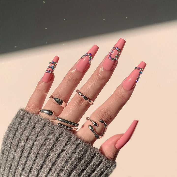 Artificial nail extensions with elegant rhinestone embellishments Bowlift