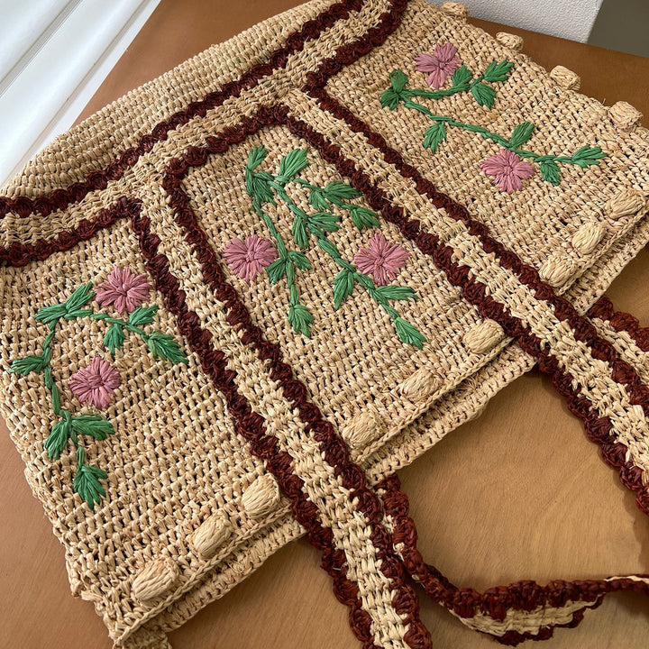 Braided shoulder bag with floral motif Bowlift