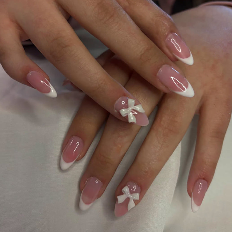 Artful nail designs with elegant tips and delicate bow motifs Bowlift