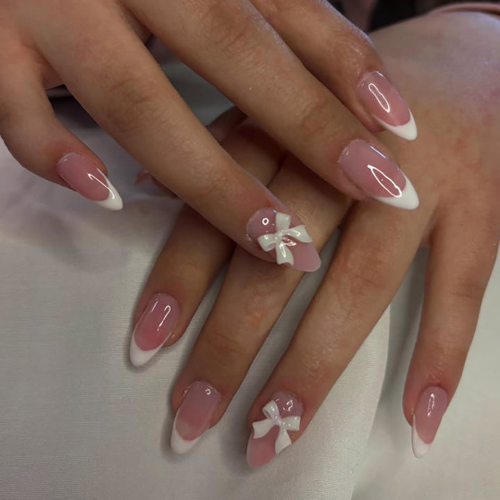Artful nail designs with elegant tips and delicate bow motifs Bowlift